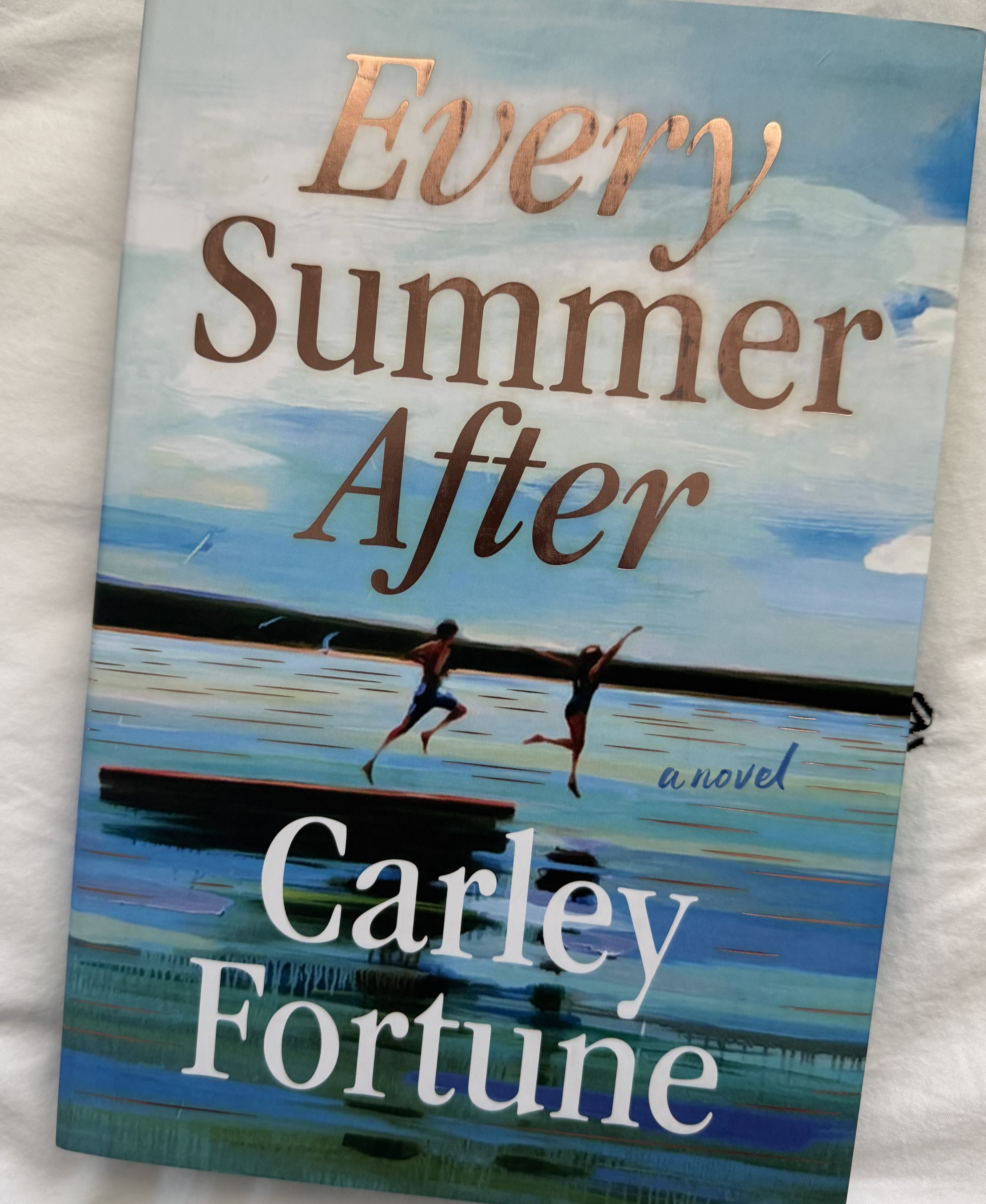 Cover of the novel 'Every Summer After' by Carley Fortune featuring illustrated children jumping into a lake against a blue sky.